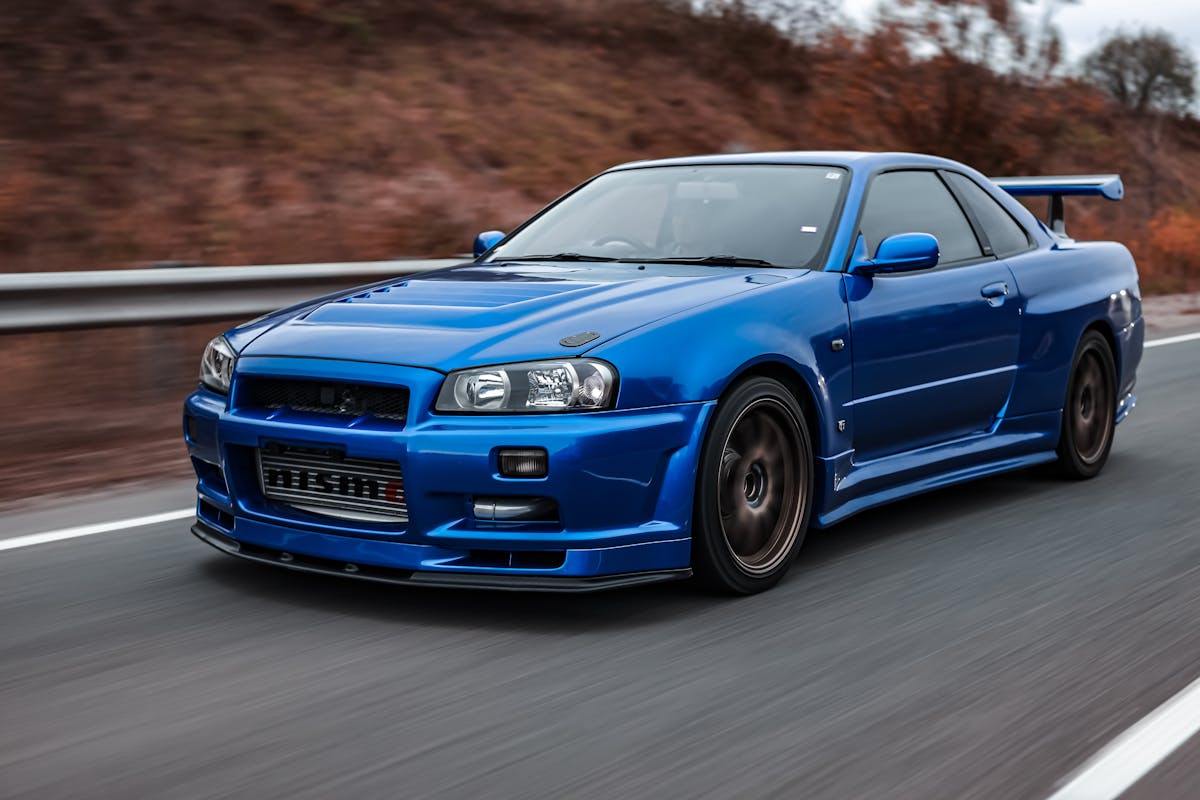 Blue Sports Car Driving on the Road