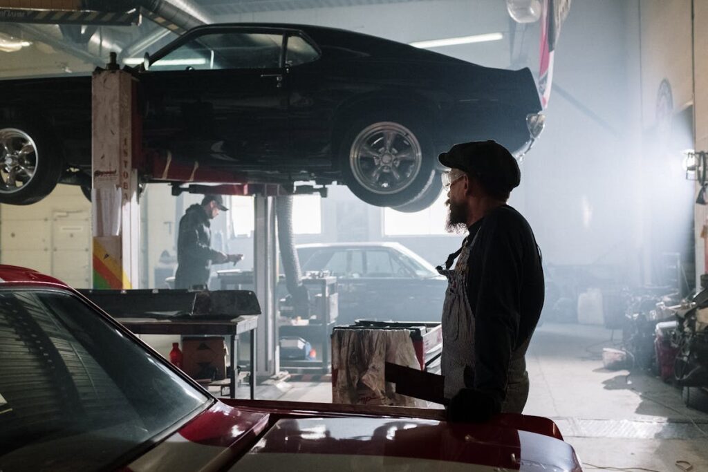 Man in Black Jacket Standing Beside Car