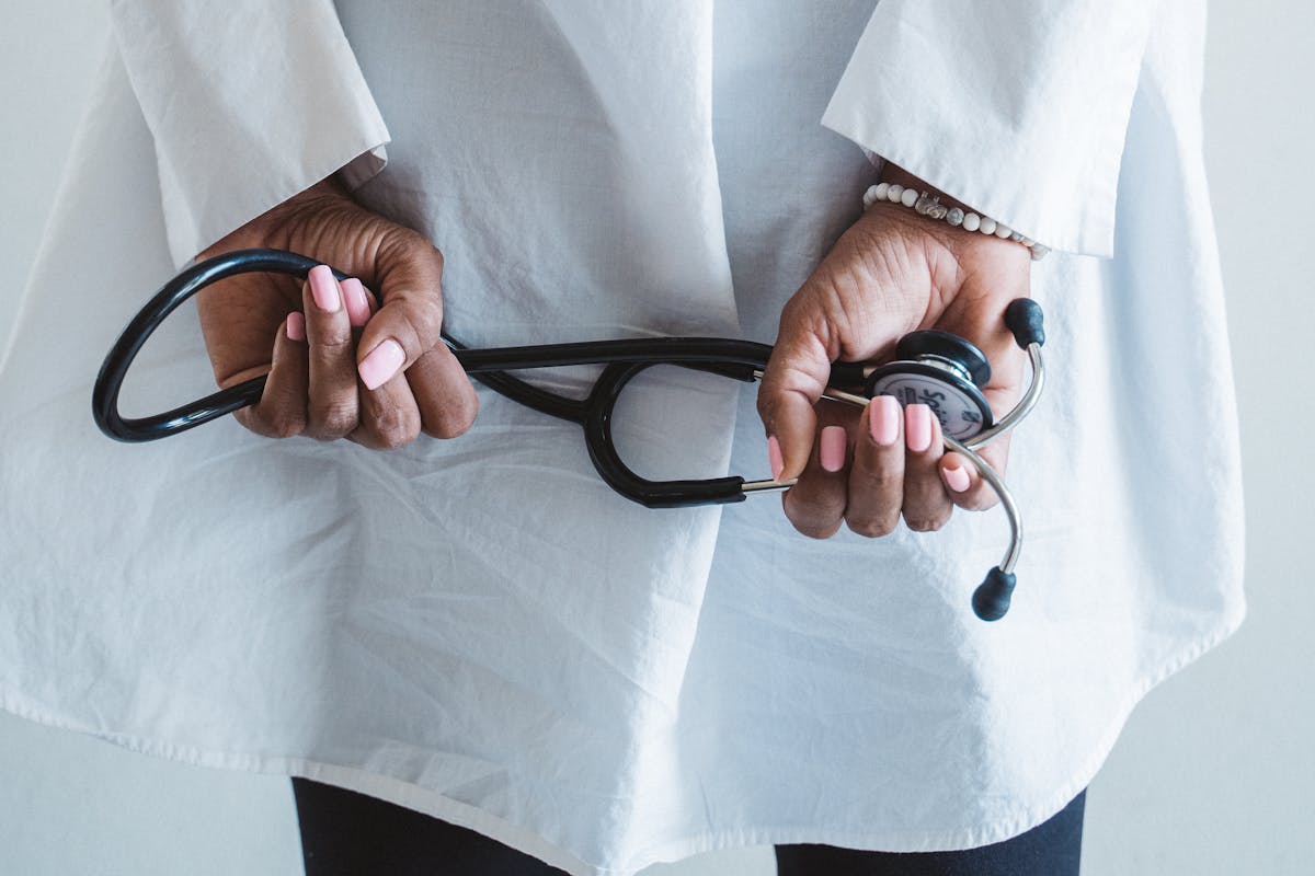 Person Holding Black and Silver Ring