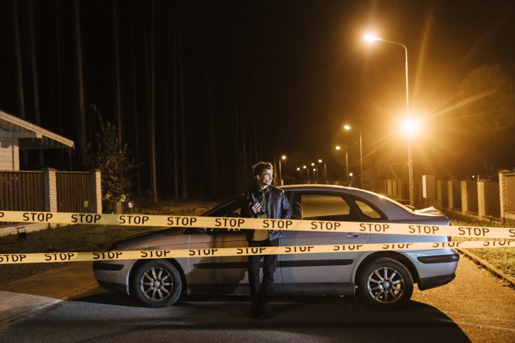 A police standing in the middle of the street with the police car