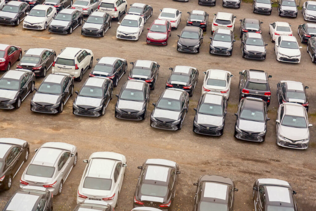Moscow, Russia - October, 2018: Many Toyota cars on reseller parking in rows from above. Toyota is a japanese manufacturer of automobiles and commercial vehicles