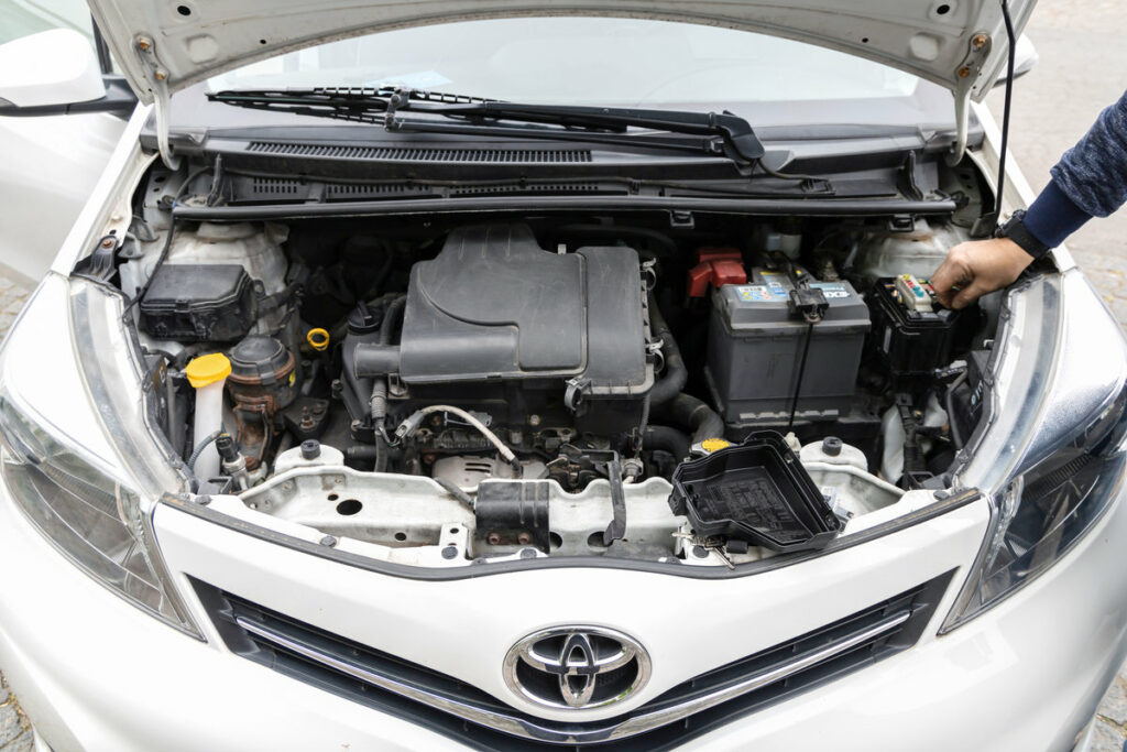 Broken Toyota Yaris car with open hood, Denmark - July 5, 2024